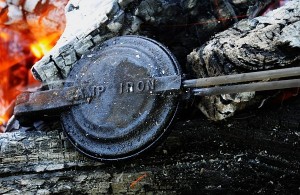 Bush pies being made in a bush pie iron on a hot bed of coals