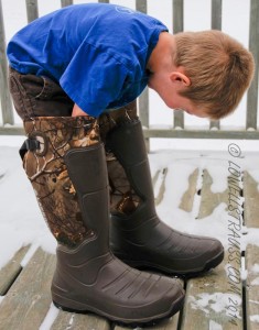 Small boy in adult boots